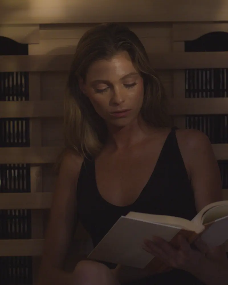 A woman reading inside a PEAK sauna